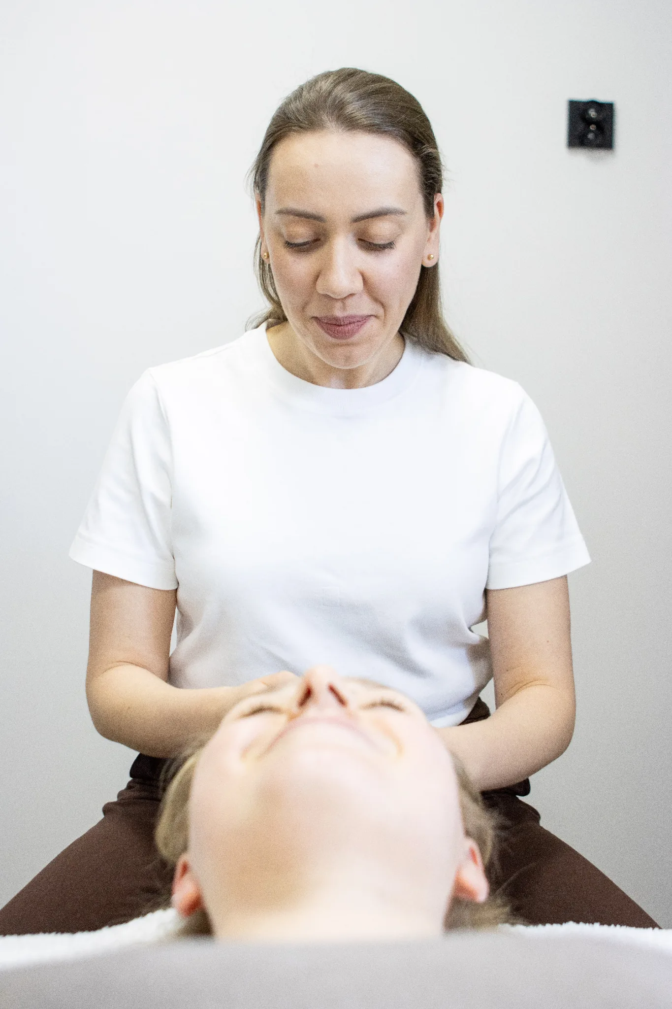 Lumi Kobido therapist Beata Nowak performing a facial massage for a client at the practice in Warsaw, Gocław